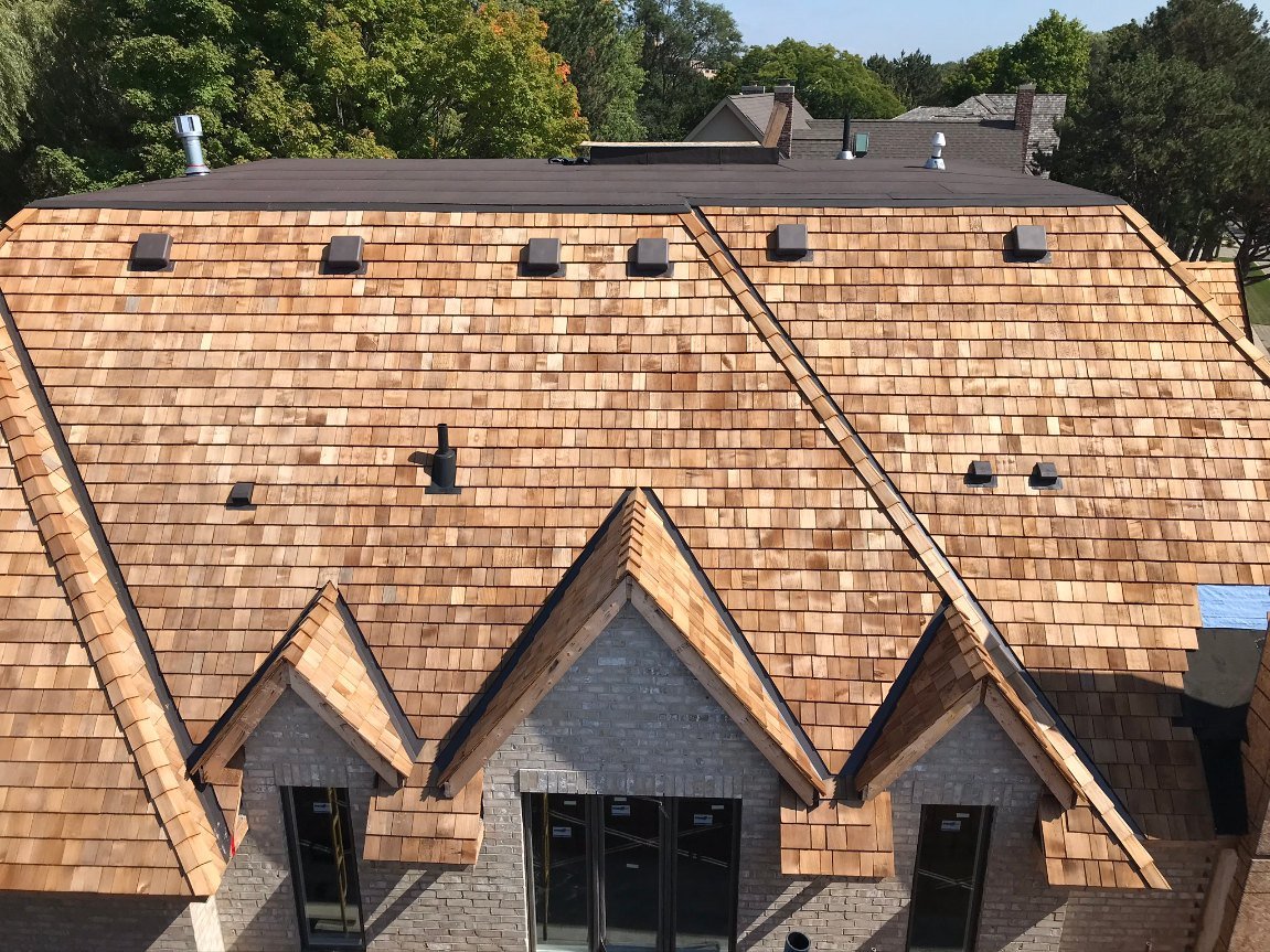 Finished cedar shake roof on a multi-gable custom home