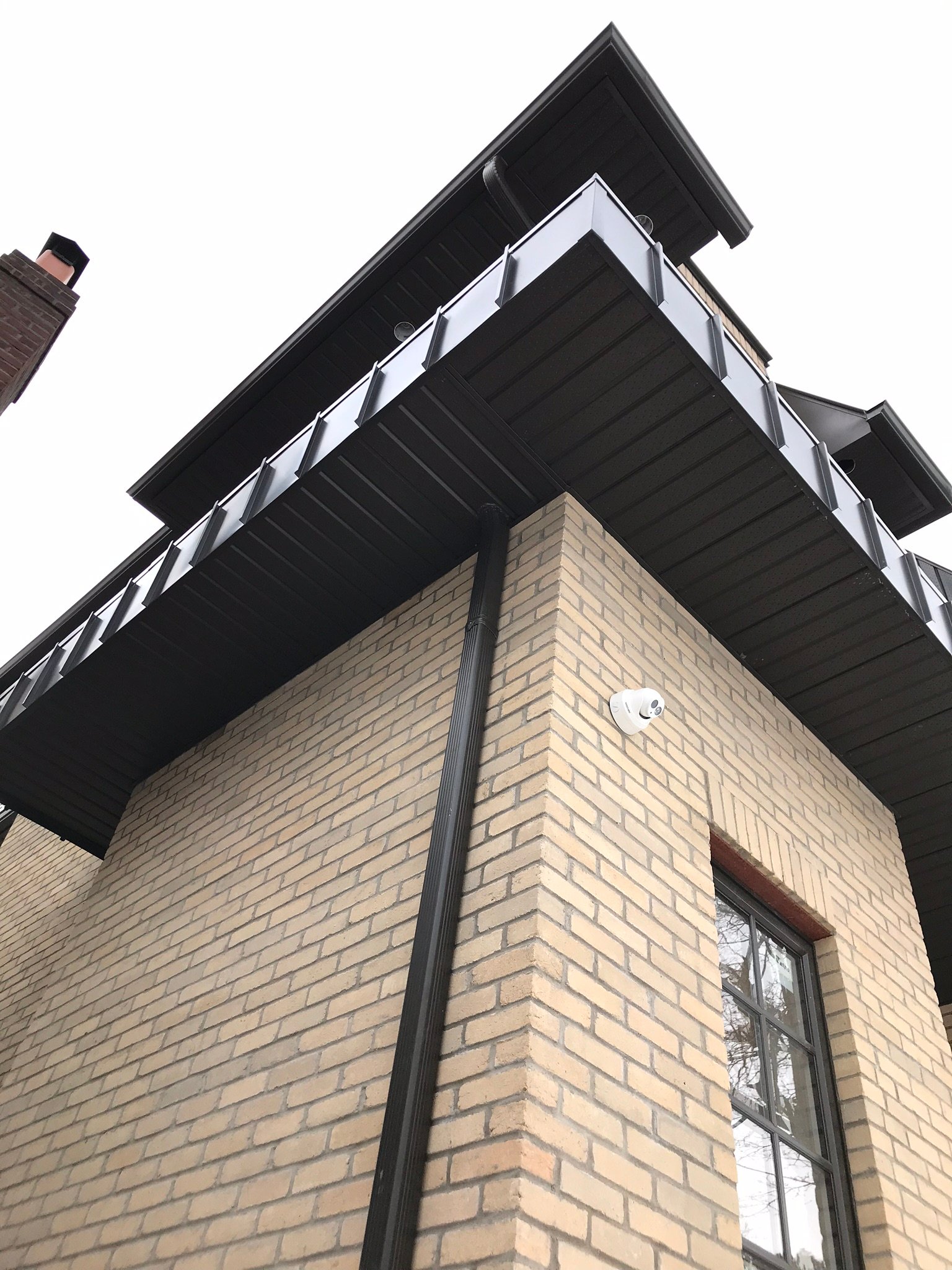 Black aluminum soffit, fascia, and downspout detail